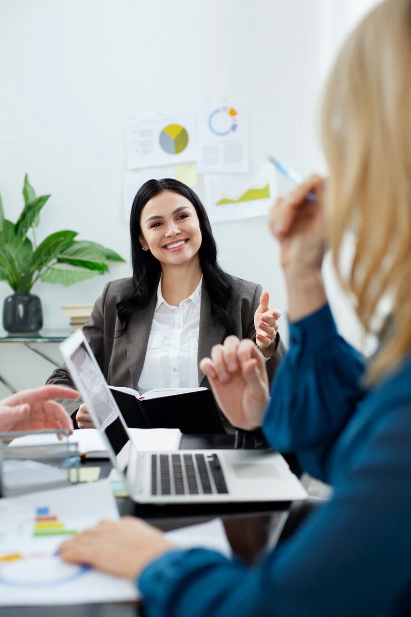 Home 7 Woman smiling during office team meeting (1)